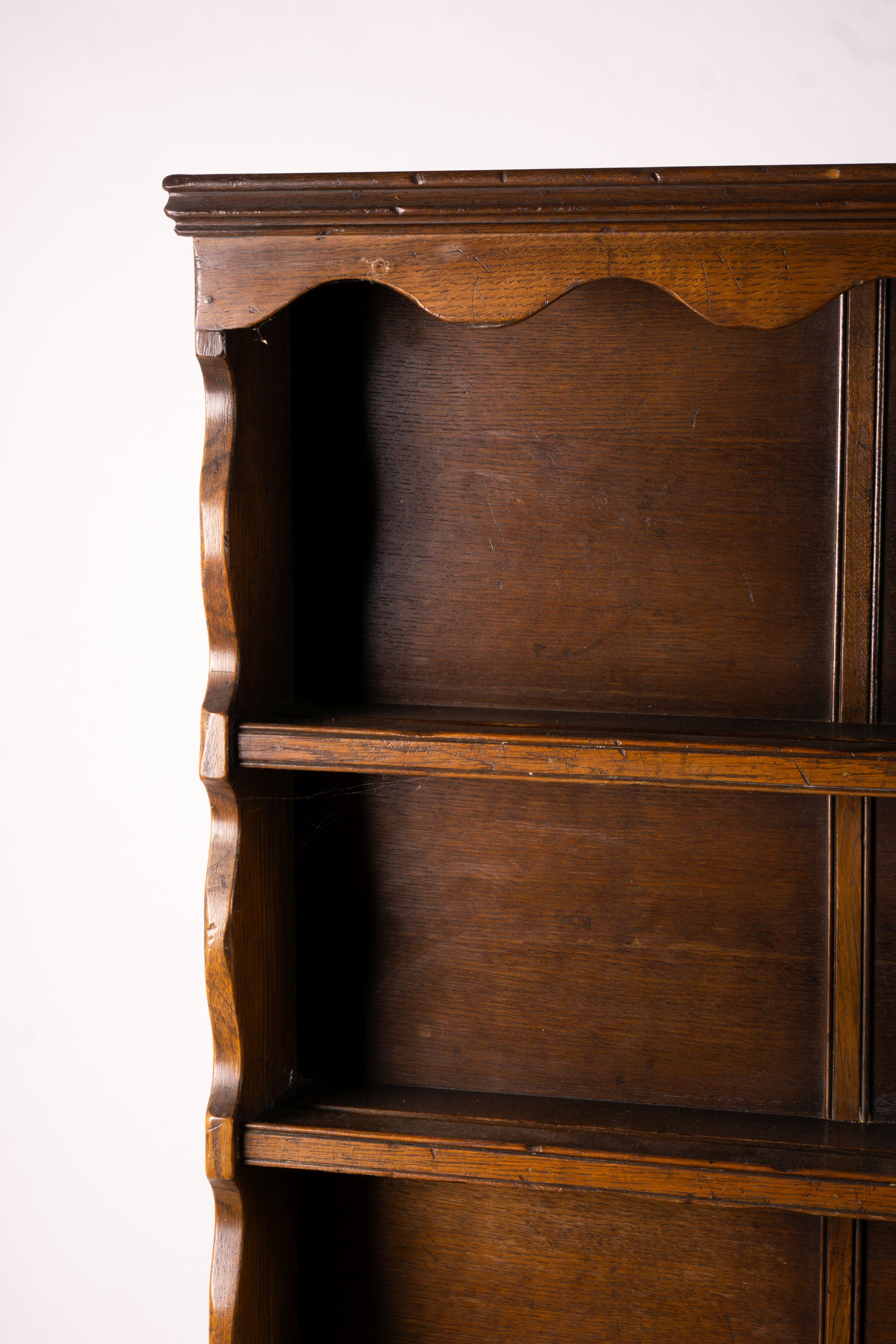 An 18th century style carved oak dresser, width 124cm, depth 46cm, height 175cm